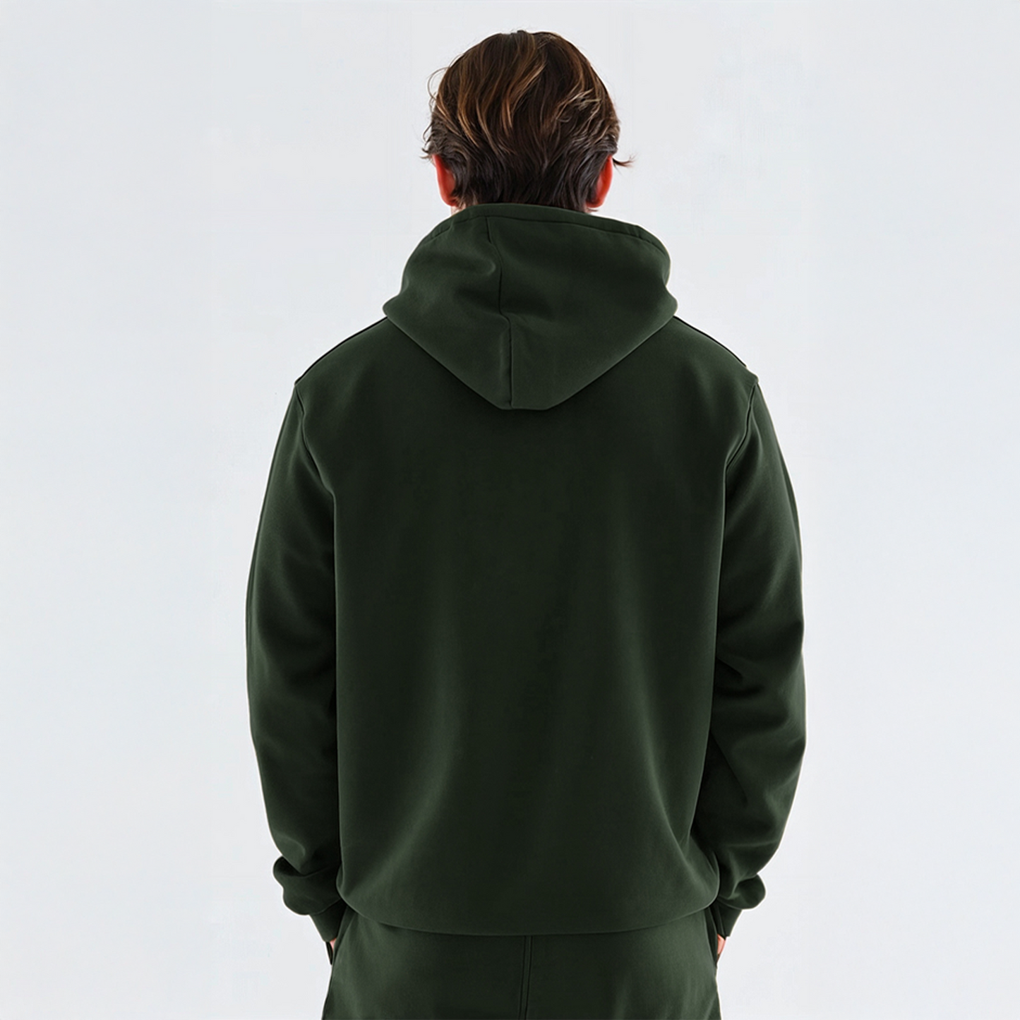 Man wearing dark green hoodie with red candlestick chart and bold text “Fearless in the Red,” styled in relaxed fit matching set