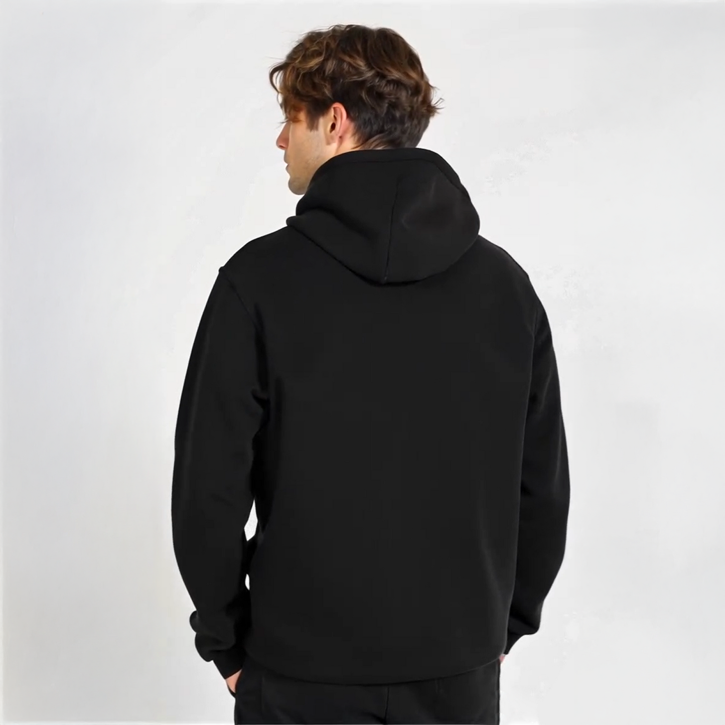 Man wearing black zip-up hoodie with white minimalist text that reads “DeFi Until I Die,” styled with hands in pockets